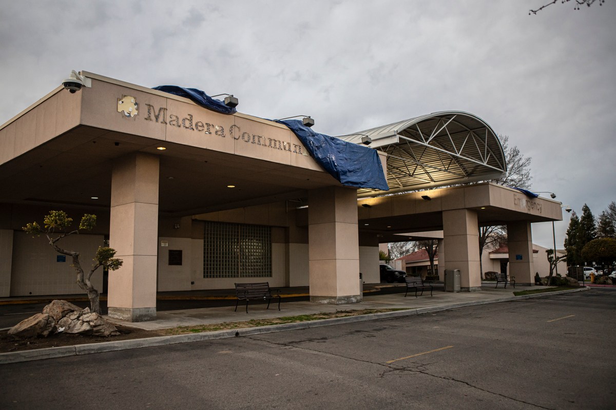 Outlines of the Madera Community Hospital sign being covered by a tarp at the Emergency Room entrance of the hospital on Jan. 2, 2023. Madera County Sheriff Tyson Pogue announced a state of emergency for the county when the hospital shut its doors due to bankruptcy. Photo by Larry Valenzuela, CalMatters/CatchLight Local