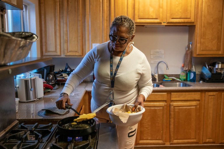 Norma Jones cooks in the communal kitchen at the Close to Home St. Mary's Center transitional housing in West Oakland on Jan. 12, 2023. Photo by Martin do Nascimento, CalMatters