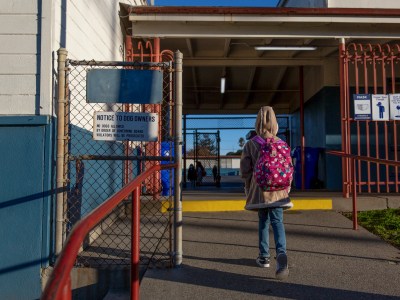 A student enters Stege Elementary School in Richmond on Feb. 6, 2023. Photo by Shelby Knowles for CalMatters