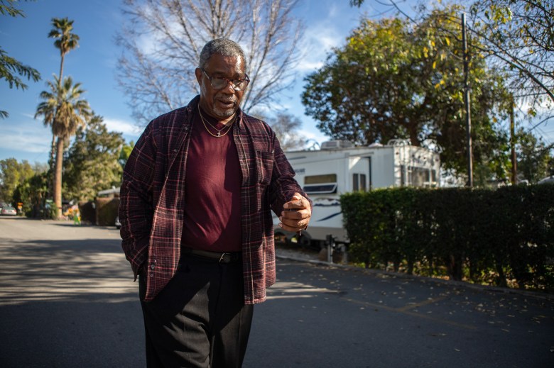 Eugene Lewis walks through a mobile home park in Van Nuys on Feb. 4, 2023. Lewis visits his wife at her RV when he gets a chance away from his halfway home. Photo by Larry Valenzuela, CalMatters/CatchLight Local