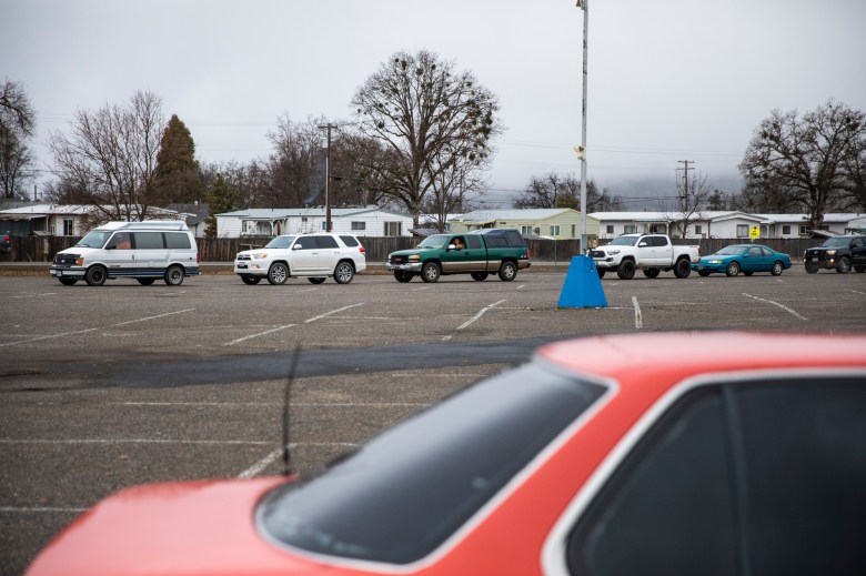 Cars line up at the Trinity County Fairgrounds for the Trinity County Food Bank distribution on Feb. 8, 2023. Photo by Martin do Nascimento, CalMatters