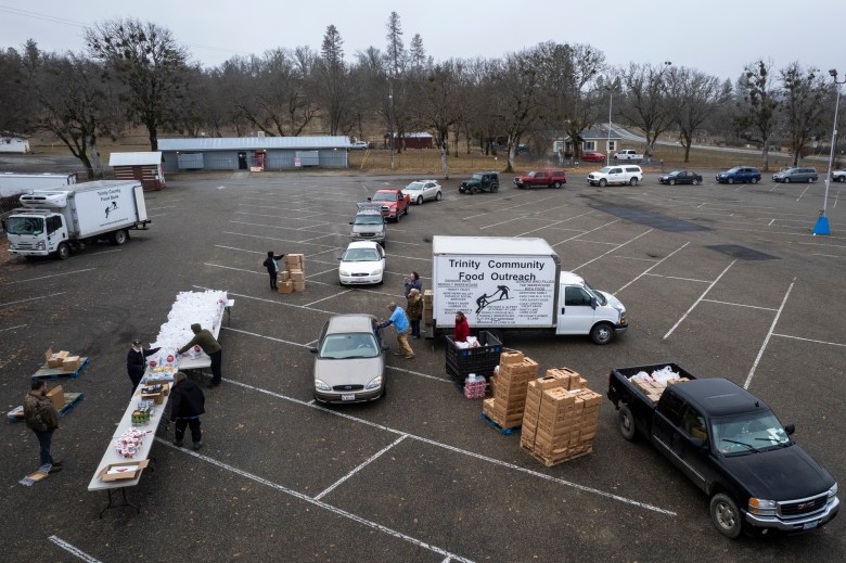 A line of cars waits to receive food from the Trinity County Food Bank at the Trinity County Fairgrounds on Feb. 8, 2023.