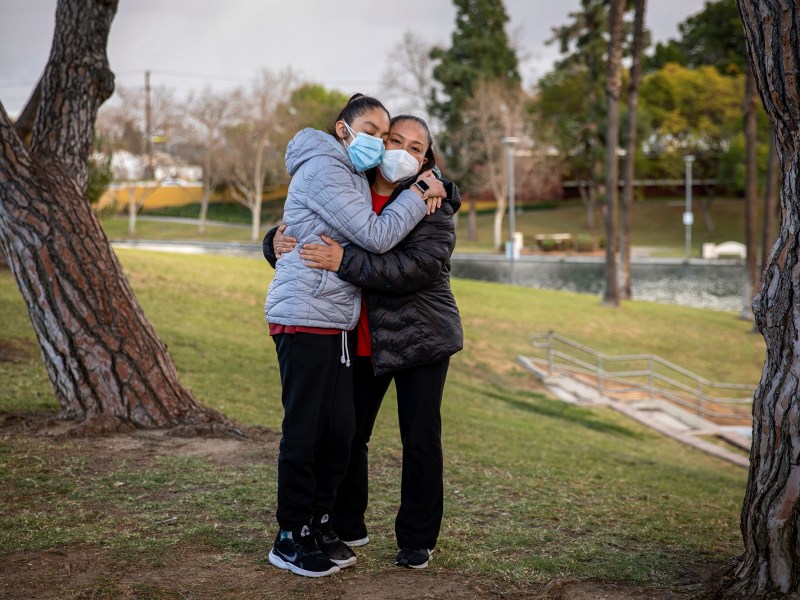 Amanda Arellano, 17, left, and her mother Maria, right, at a park near their home in Los Angeles on Feb. 22, 2022. Amanda said she believes schools need to focus more are helping students with mental health struggles that have been caused by the pandemic. “Especially those with special needs, we are the community who have been much more impacted, especially with physical and mental problems,” she said. Amanda has autism, cerebral palsy and attention deficit hyperactivity disorder. Amanda said the start of the pandemic had more positives because it brought more resources for distance learning and the schools had more resources for mental health, but she feels that those things have faded with time and with classes now being in-person again. Photo by Alisha Jucevic for CalMatters