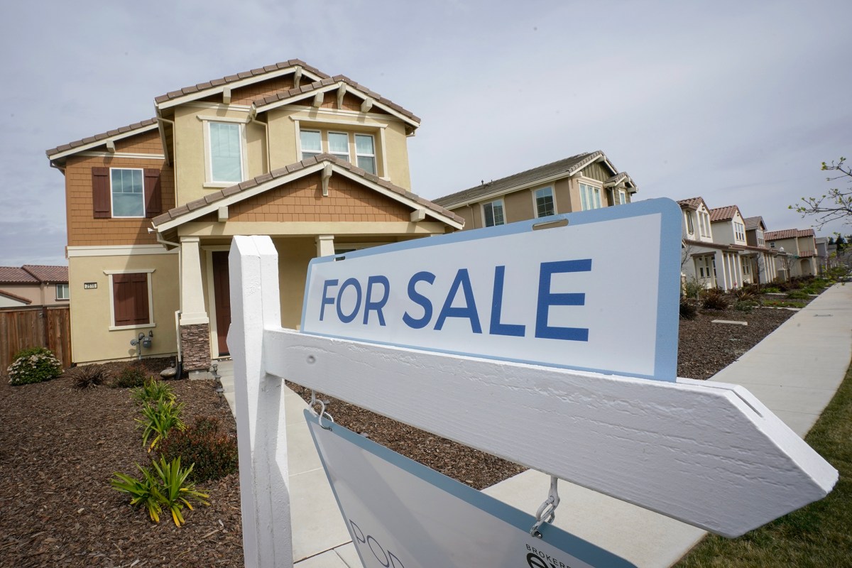 A "for sale" sign is posted in front of a home in Sacramento on March 3, 2022. Photo by Rich Pedroncelli, AP Photo