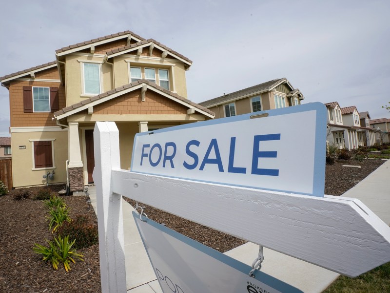 A "for sale" sign is posted in front of a home in Sacramento on March 3, 2022. Photo by Rich Pedroncelli, AP Photo