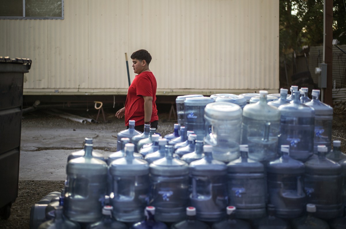 A stack of empty five-gallon water containers at Shady Lane Estates in Thermal on March 23, 2023. According to some residents, there is no clean drinking water from the mobile park, so these five-gallon containers are their only option. Pablo Unzueta for CalMatter