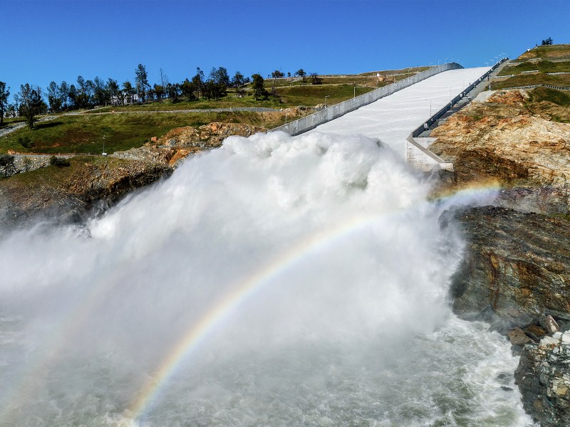 Water rushes out of the Oroville Spillway at Lake Oroville in Butte County, on March 26, 2023. California ended its 2022-23 water year on Saturday, Sept. 30, 2023. After years of severe drought, the reservoirs in the state water project ended the year at 128% of their historical average. That includes Lake Oroville. Photo by Noah Berger, AP Photo