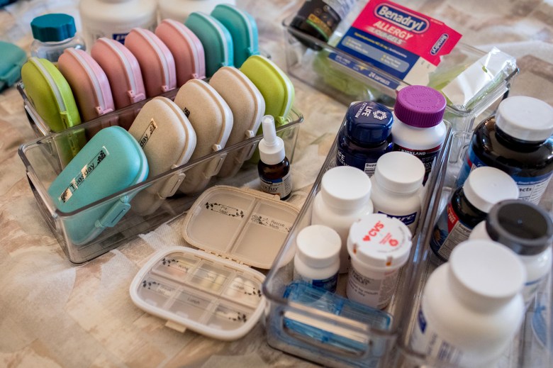 Some of Mindy Lym's medications and supplements living with long COVID. Lym has been living with long COVID since the summer of 2022. After months of bed rest, she's now living in Camas, Washington with her girlfriend where her symptoms are improving but are still a day to day challenge.