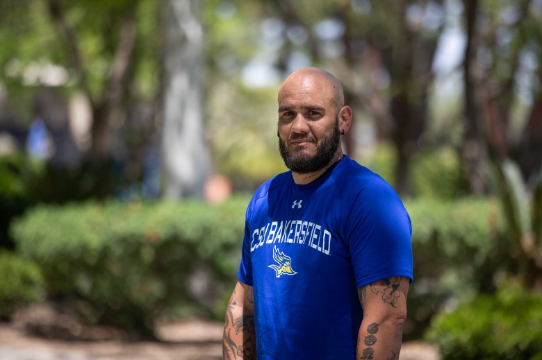 Larry Gonzales, a graduating senior majoring in sociology, outside the science building at Cal State Bakersfield on April 22, 2024. Gonzales is a part of the Project Rebound program and a member of the student government on campus. Photo by Larry Valenzuela, CalMatters/CatchLight Local