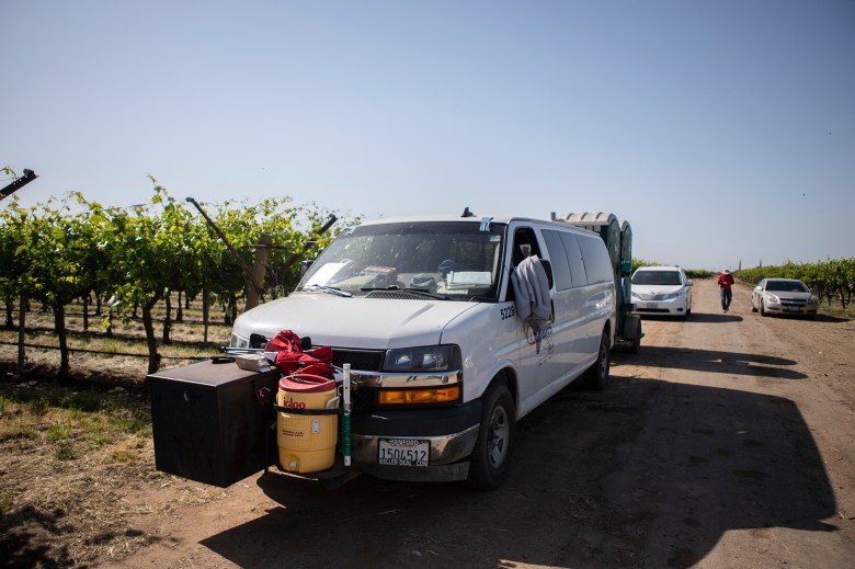 A CalVans van parked in a field in a vineyard outside of Reedley on May 2, 2024. CalVans is a nonprofit trying to provide safe vans for farm workers to be transported to work. Photo by Larry Valenzuela, CalMatters/CatchLight Local