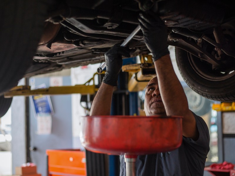 Walter Preza works on a car at J & R Auto Repair shop mechanic in San Francisco on Thursday, May 12, 2022. Photo by Nina Riggio for CalMatters