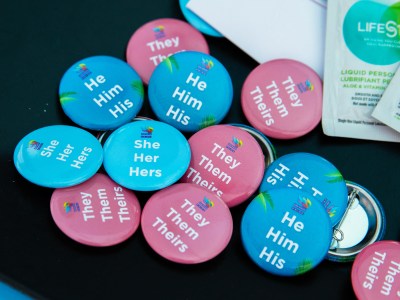 Buttons with different pronouns at the We Care Health Fair in San Diego on May 18, 2024. Photo by Adriana Heldiz, CalMatters