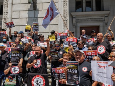 Ride-share driver and SEIU Gig Workers Union member John Mejia, center, speaks during a press conference outside of the Supreme Court of California in San Francisco on May 21, 2024. The state Supreme Court heard oral arguments on Prop. 22, a ballot initiative that allows ride-share companies, such as Uber and Lyft, to classify drivers as independent contractors. Photo by Juliana Yamada for CalMatters