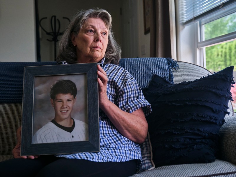 Susan Ottele holding a photo of her son Adam Joseph Collier who committed suicide while in solitary confinement in a California state prison. Photo by Tojo Andrianarivo for CalMatters