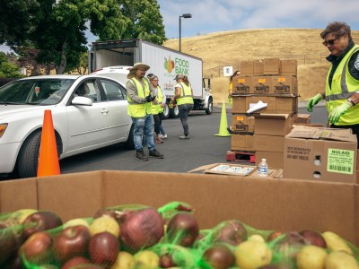 Volunteers and staff with the Food Bank of Contra Costa and Solano load groceries into cars in Vallejo on June 7, 2023. Photo by Shelby Knowles for CalMatters