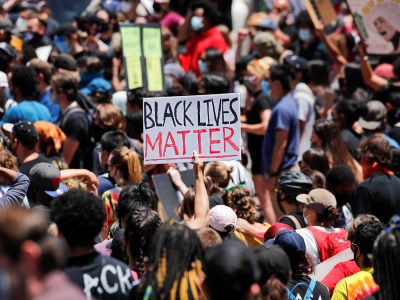 People hold placards as they attend a protest against racial inequality in the aftermath of the killing of George Floyd while in Minneapolis police custody, in Los Angeles, on. June 8, 2020. Photo by Mike Blake, Reuters