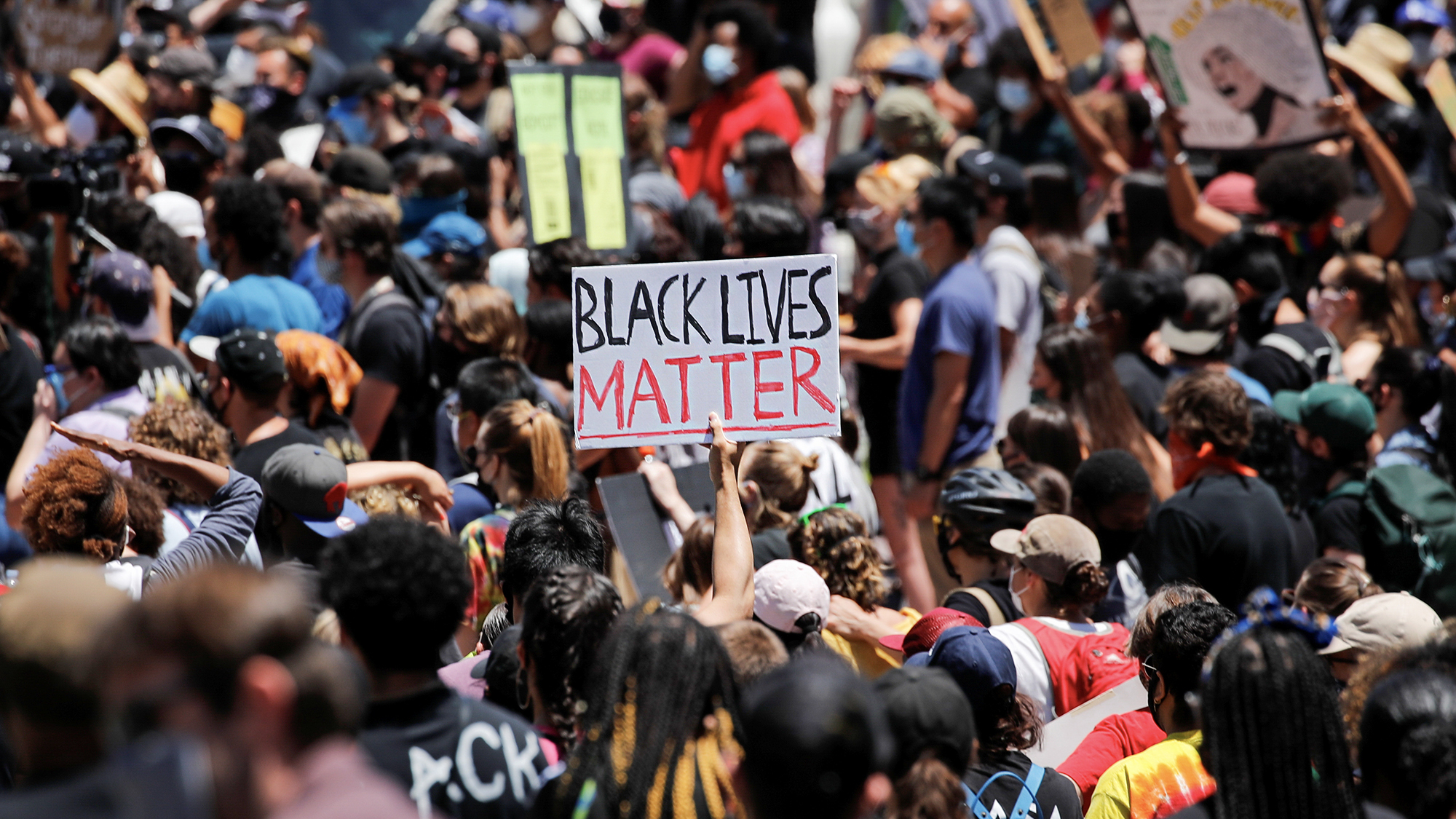 People hold placards as they attend a protest against racial inequality in the aftermath of the killing of George Floyd while in Minneapolis police custody, in Los Angeles, on. June 8, 2020. Photo by Mike Blake, Reuters