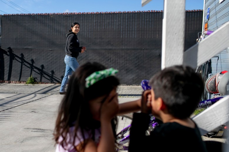 Claudeth plays a hiding game with her niece and nephew while babysitting. Photo by Anne Wernikoff, CalMatters