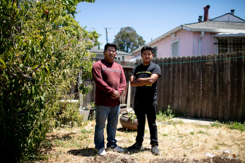 Eduardo with his father Emilio in the backyard of their home. Photo by Anne Wernikoff, CalMatters