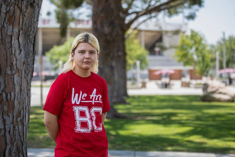 Cecil Dexter, a member of the Lavender Initiative at Bakersfield College, stands at the entrance of the Campus Center on June 14, 2023. Photo by Larry Valenzuela, CalMatters/CatchLight Local