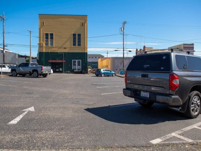 A mostly empty parking lot on 3rd Street between G and H Streets in Eureka on June 17, 2024. The lot is the site of a proposed Humboldt Transit Authority Hub that would include housing. Photo by Mark McKenna for CalMatters