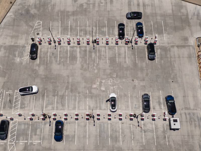 Tesla vehicles charging at the Tesla Supercharger lot in Kettleman City on June 23, 2024. Photo by Larry Valenzuela, CalMatters/CatchLight Local