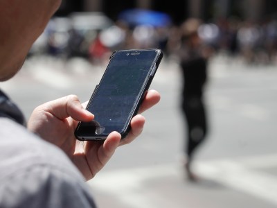 A person holds their mobile phone in San Francisco on July 16, 2019. Photo by Jeff Chiu, AP Photo