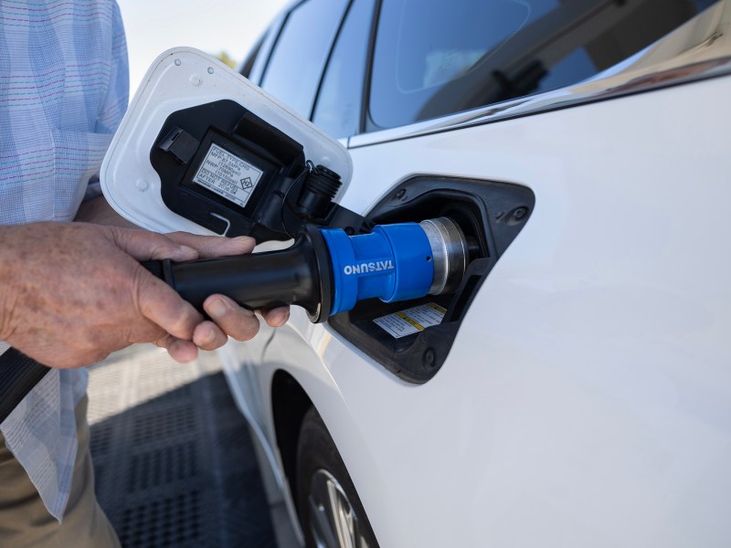 A hydrogen vehicle owner adds fuel to his vehicle at an Iwatani hydrogen fuel station in West Sacramento on July 25, 2023. Photo by Miguel Gutierrez Jr., CalMatters