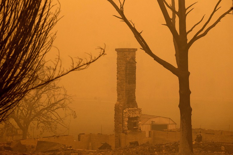 A chimney stands at a destroyed building as the McKinney Fire burns in Klamath National Forest on July 31, 2022