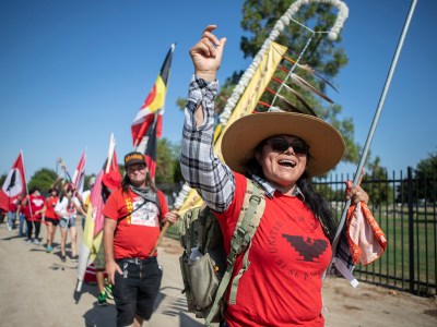 United Farm Workers member Veronica Mota leads marchers in chants through Delano on Aug. 3, 2022. Photo by Larry Valenzuela, CalMatters/CatchLight Local