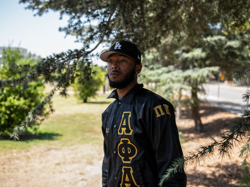 Christopher Carter, 22, a fifth-year communications student at Cal State Northridge, stands for a portrait at CSUN in Northridge on August 19, 2022. “I want the world to know that as a young Black man, you can achieve big things in life,” Carter said. “Through all the trials and tribulations, don’t quit.” Photo by Pablo Unzueta for CalMatters