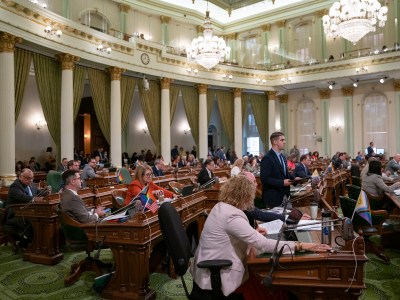 A room full of legislatures sitting during the state Assembly during a floor session at the state Capitol.