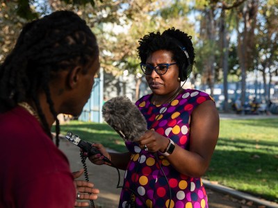 alMatters Investigative Reporter Byrhonda Lyons interviews Ernest Howard at Leimert Park in Los Angeles on Sept. 28, 2023. Photo by Adriana Heldiz, CalMatters