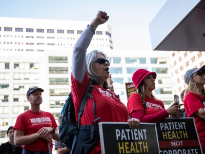 Striking Kaiser Permanente mental health worker Lisa Galan others stage a die-in at the Kaiser Headquarters in Oakland on Oct. 7, 2022. Photo by Martin do Nascimento, CalMatters