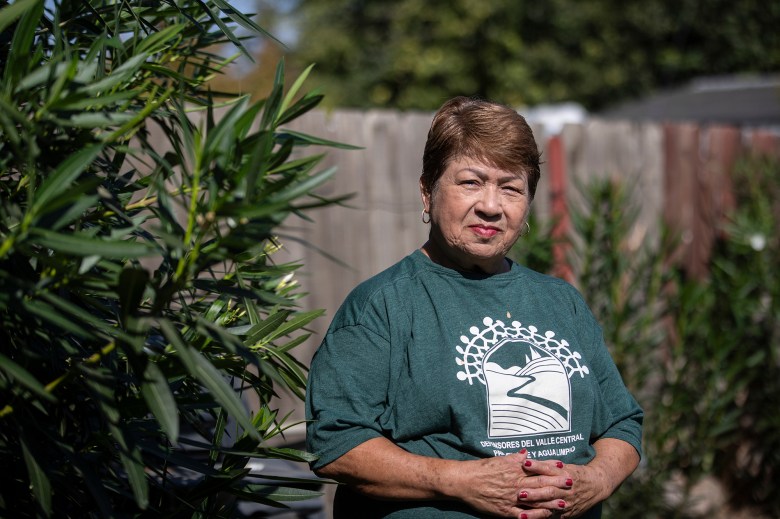 Maria Arevalo stands in the back yard of her daughters home in Visalia on Oct. 10, 2023. Arevalo, who has lived in Pixley for 47 years, says the chemicals given off from the dairy has affected her breathing. Photo by Larry Valenzuela, CalMatters/CatchLight Local