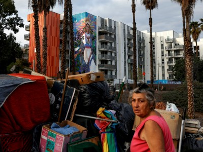 Alard Gavorkian, an unhoused woman in downtown Los Angeles, tends to her belongings on Jan. 29, 2022. Photo by Shannon Stapleton, Reuters