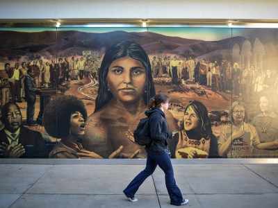 “La Memoria de la Tierra,” a mural created by Judith Baca, resides on the north side of Ackerman Union at UCLA in Los Angeles on Nov. 9, 2022. The mural is approximately 80 feet and made up of three 26-foot-long glass panels. Pablo Unzueta for CalMatters