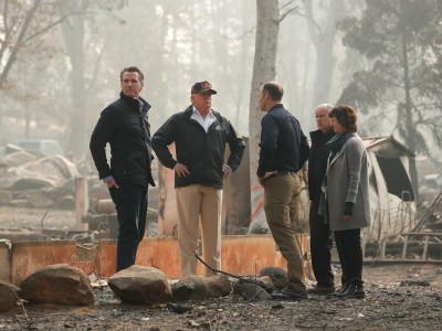 Former U.S. President Donald Trump and other California lawmakers stand amongst burnt structures, rubble and debris at a mobile home park that was destroyed during a wildfire.