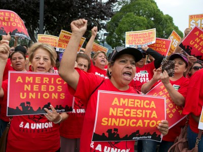 Josefina Pulido, center, cheers while holding a sign that read 'America needs unions' during a Service Employees International Union rally for higher wages at McDonald's in San Jose on September 4, 2017. Bay Area workers are joining the national 'Fight for $15' protest and are part of a nationwide union organized Labor Day action. Photo by LiPo Ching, Bay Area News Group