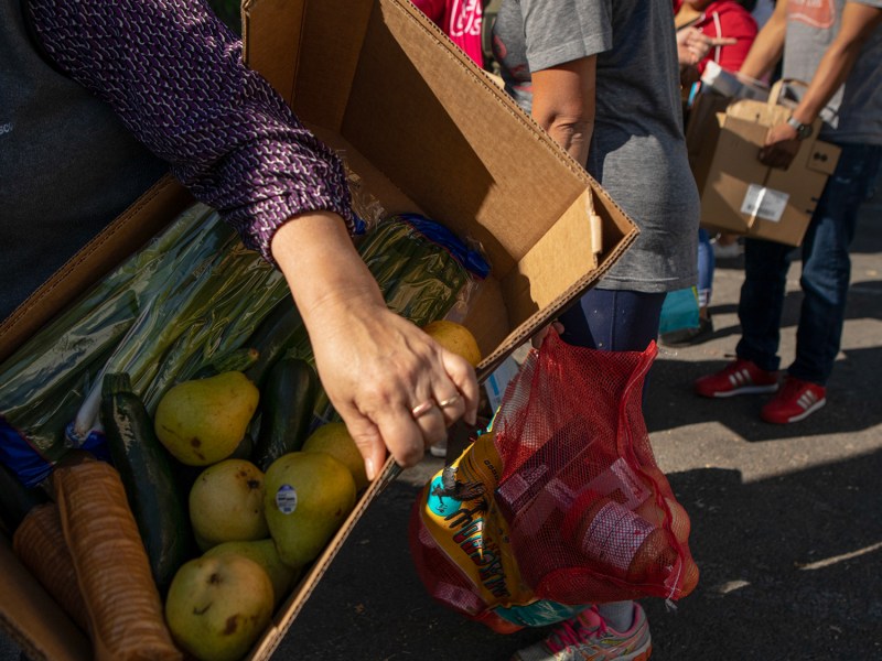 Families carry boxes full of fresh produce during a food bank event at El Verano elementary on Nov. 1, 2019. Photo by Anne Wernikoff, CalMatters